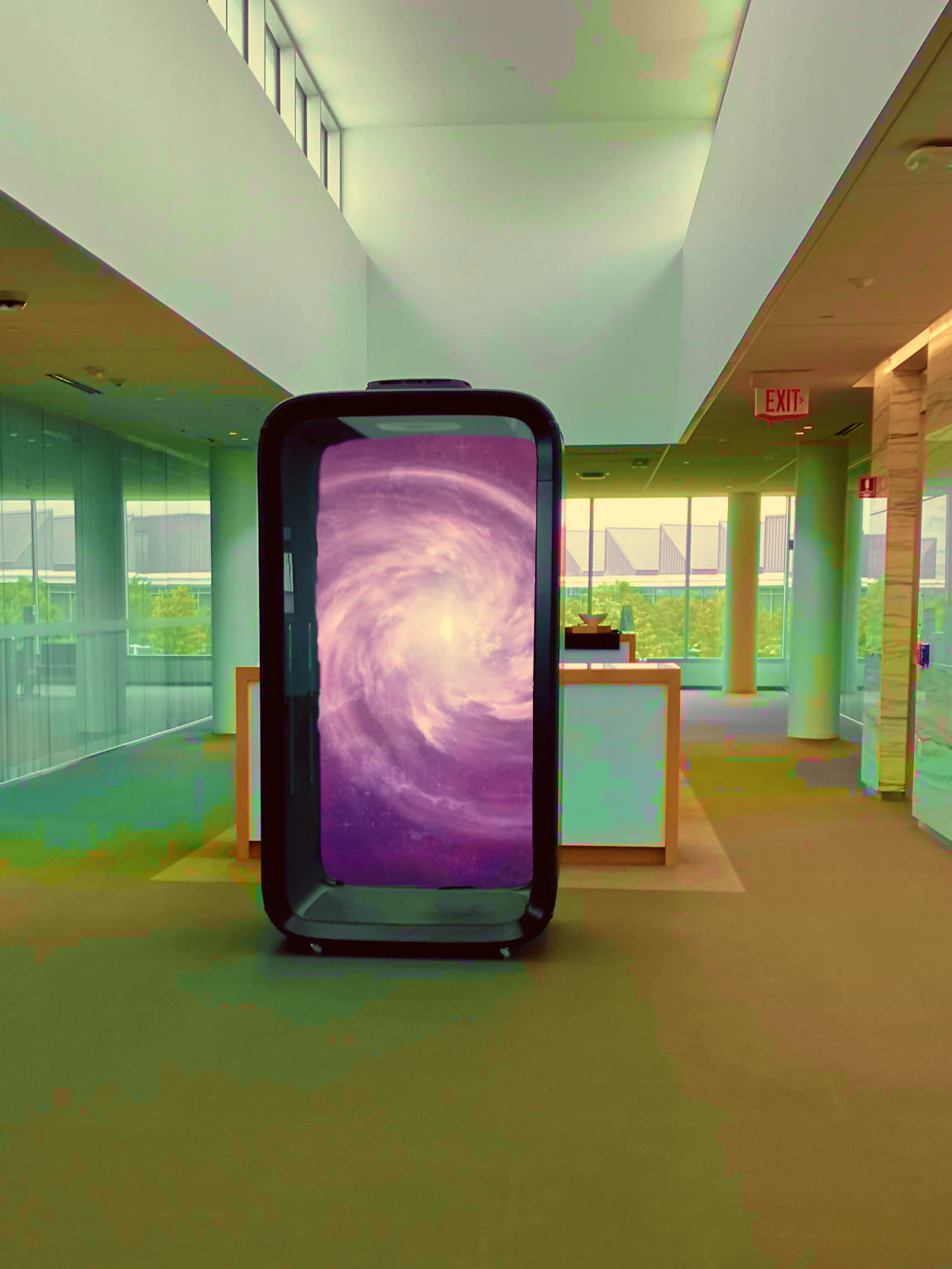 After image: The office cubicle has been turned into a purple swirly portal. The saturation is incredibly high, making the entire environment look unnatural and colourful. It resembles a more saturated version of 'The Backrooms' liminal space.