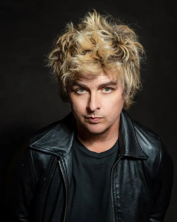 Before image: Billie Joe Armstrong from Green Day wearing a leather jacket and looking at the camera. The image has a high exposure.