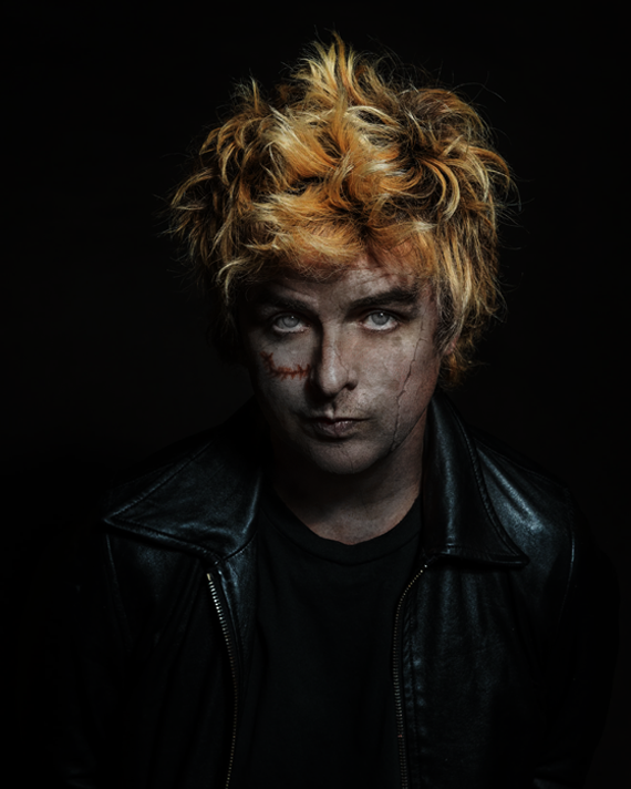 After image: Billie Joe Armstrong from Green Day edited to look like a zombie with gray mottled skin, a crack on his face, and a scar. The image has a higher contrast and a much lower exposure.